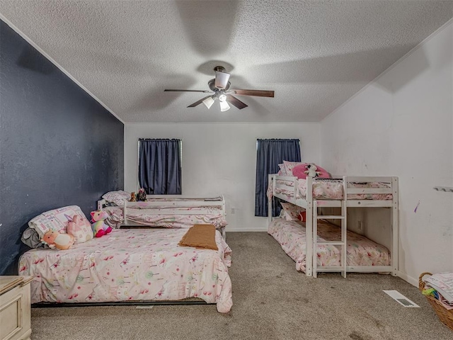 carpeted bedroom with a ceiling fan, a textured ceiling, and visible vents
