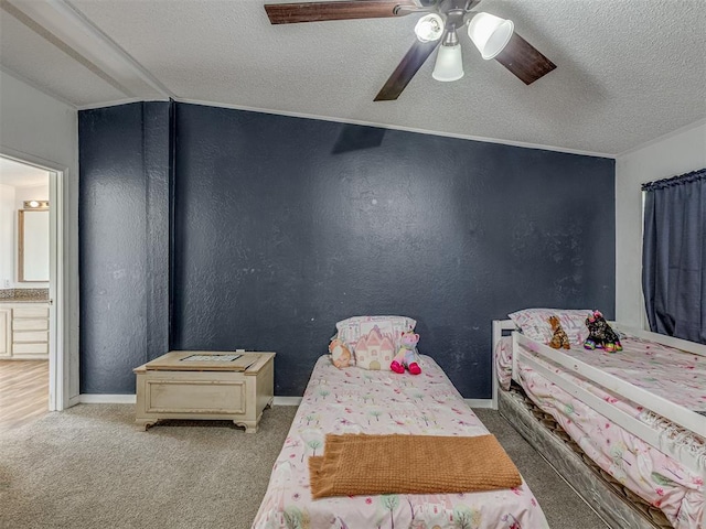 bedroom with carpet floors, a ceiling fan, a textured ceiling, and a textured wall