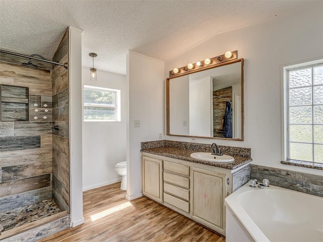 full bath featuring a garden tub, vanity, wood finished floors, toilet, and a tile shower