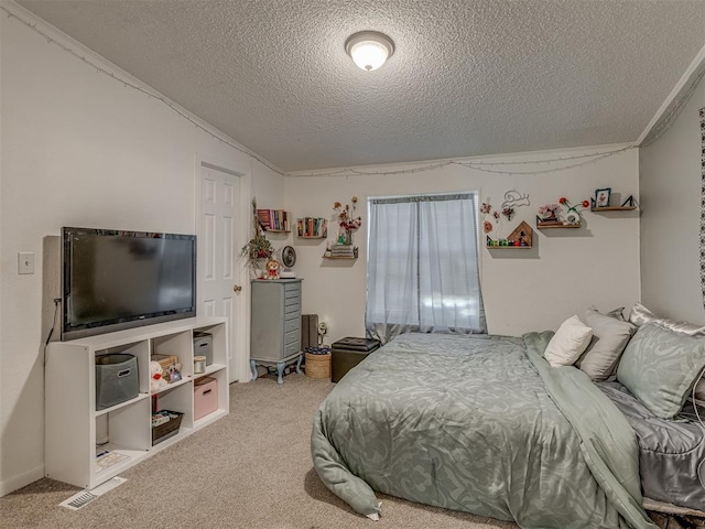 bedroom with a textured ceiling and carpet