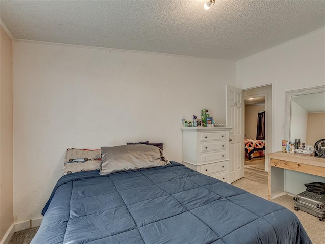 bedroom with light colored carpet, a textured ceiling, and crown molding