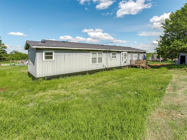 rear view of property with a yard