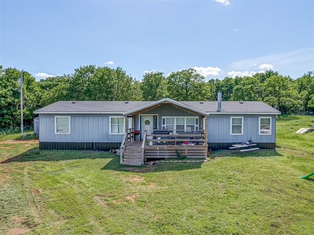 back of house with a wooden deck and a yard