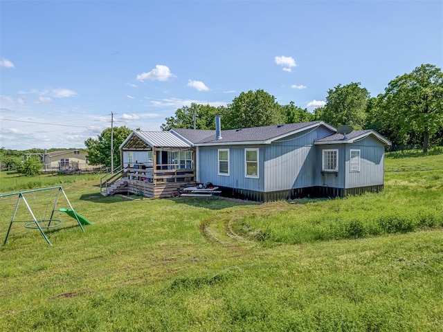 rear view of house with a yard and a deck