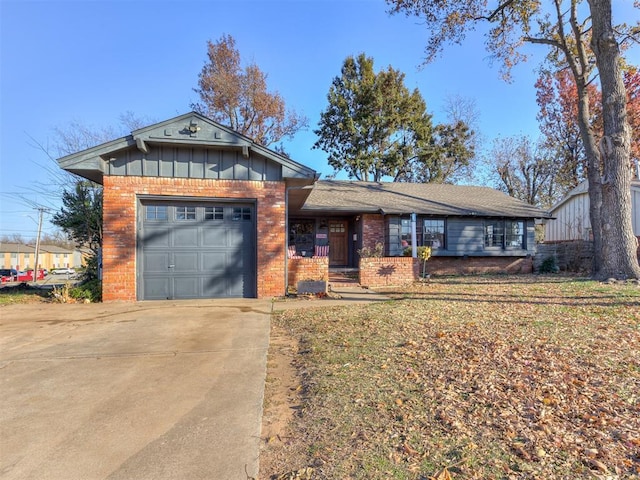 view of front facade featuring board and batten siding, brick siding, driveway, and a garage