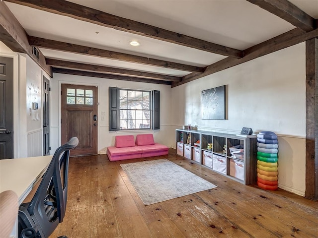 interior space with beamed ceiling and hardwood / wood-style floors