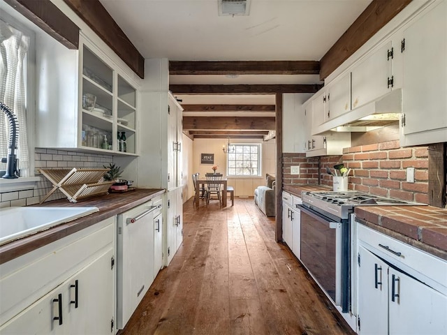 kitchen featuring range with gas cooktop, backsplash, visible vents, wood counters, and under cabinet range hood