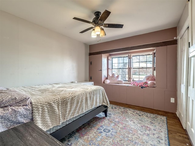 bedroom with ceiling fan and wood finished floors