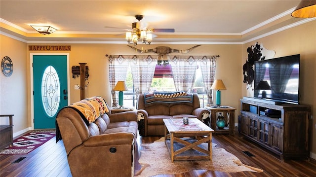 living room featuring baseboards, ornamental molding, ceiling fan, and wood finished floors