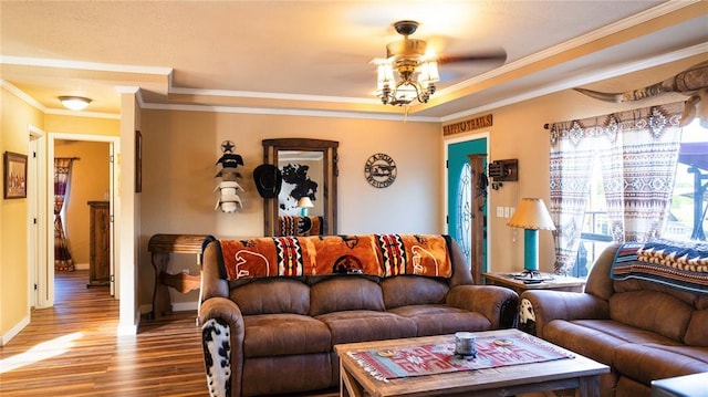 living room with crown molding, a ceiling fan, baseboards, and wood finished floors