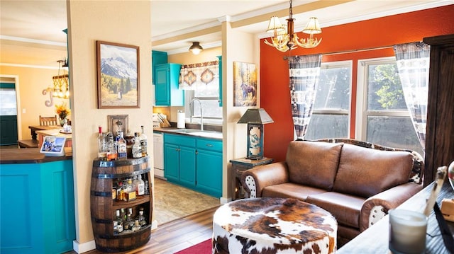 living area featuring an inviting chandelier, ornamental molding, and light wood-style flooring