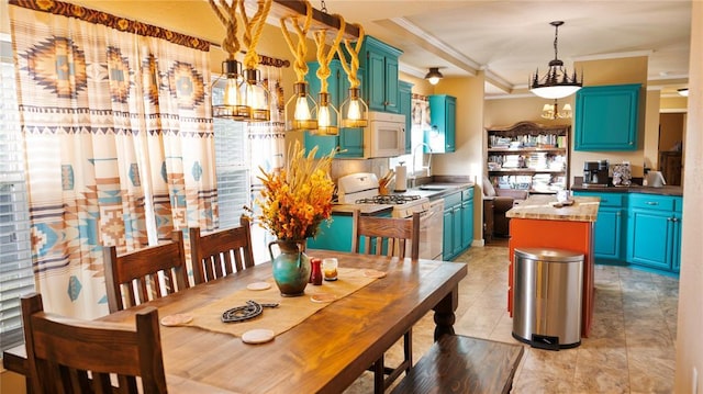 kitchen featuring crown molding, a notable chandelier, a sink, white appliances, and a kitchen island