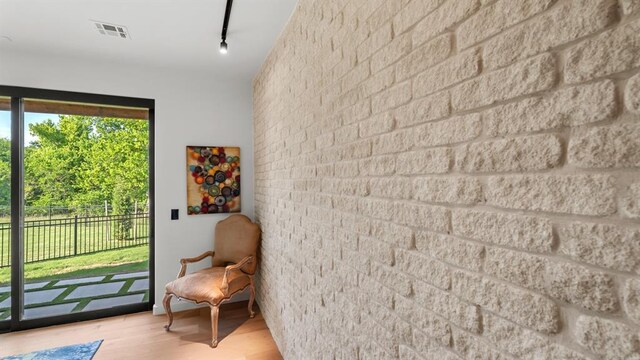 sitting room featuring wood finished floors and rail lighting