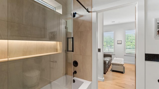 bathroom with shower / bathtub combination and wood finished floors