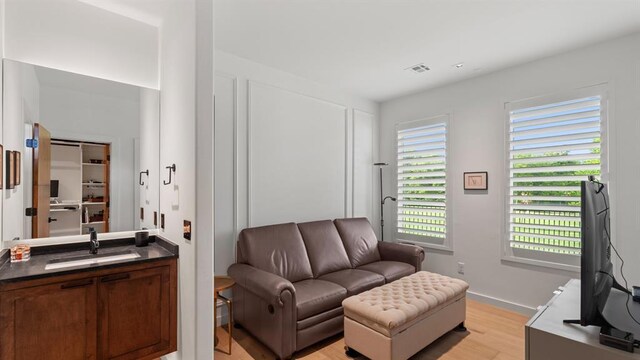 living room featuring light wood-type flooring and baseboards