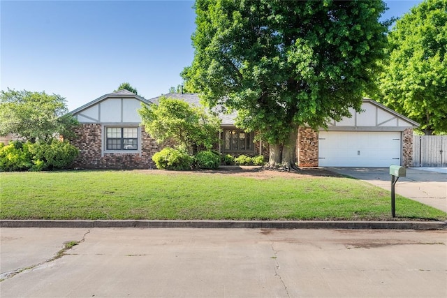 view of property hidden behind natural elements with a garage, a front yard, and concrete driveway