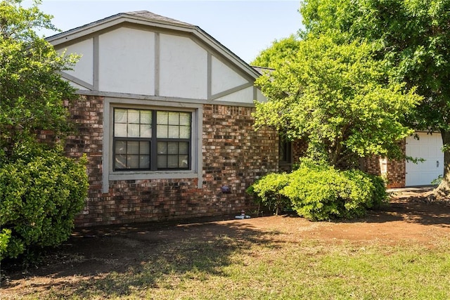 view of side of home featuring brick siding