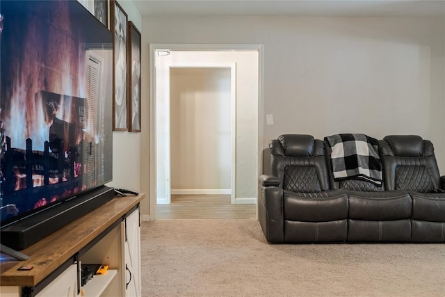 carpeted living room with baseboards