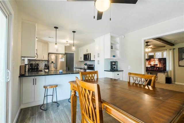 dining area with a ceiling fan, baseboards, visible vents, and dark wood-style floors