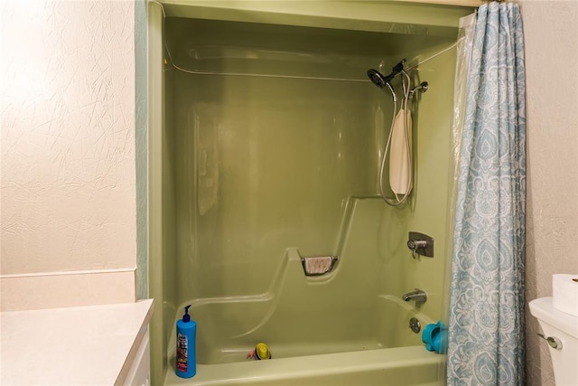 bathroom with a textured wall, shower / bath combo, and toilet