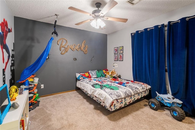 bedroom featuring carpet, a ceiling fan, a textured ceiling, and visible vents