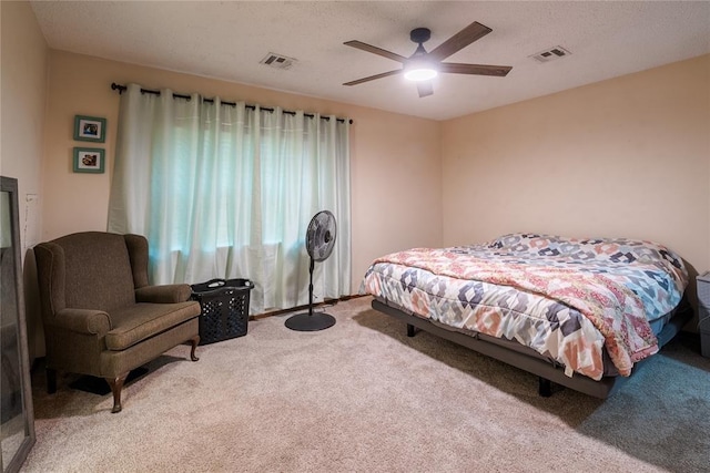 carpeted bedroom with ceiling fan and visible vents
