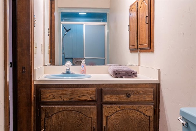 bathroom with vanity and a shower with shower door