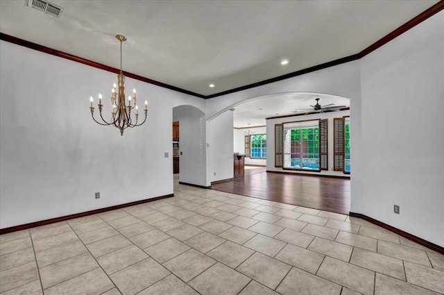 unfurnished room with crown molding, arched walkways, baseboards, light tile patterned floors, and visible vents