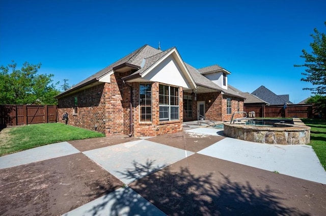 view of front of home featuring a fenced backyard, a front yard, a patio area, and brick siding