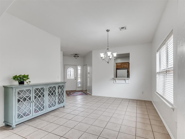 interior space featuring an inviting chandelier, light tile patterned floors, visible vents, and baseboards