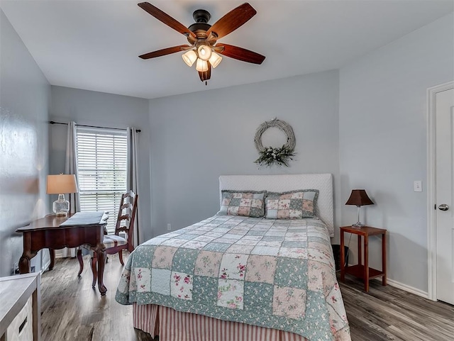 bedroom with baseboards, ceiling fan, and wood finished floors