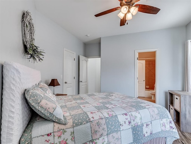 bedroom featuring ceiling fan, ensuite bath, and wood finished floors