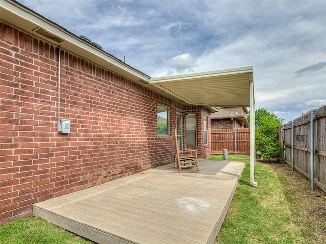 wooden terrace with a yard, entry steps, and a fenced backyard