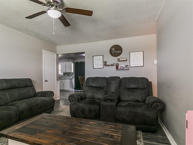 5416 S Independence Ave, Oklahoma City, OK 73119 - living room with dark wood-type flooring, a ceiling fan, a textured ceiling, and baseboards