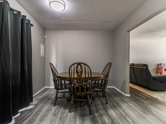 5416 S Independence Ave, Oklahoma City, OK 73119 - dining room featuring baseboards, a textured ceiling, and wood finished floors