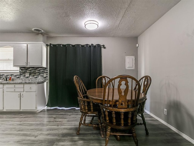 5416 S Independence Ave, Oklahoma City, OK 73119 - dining area with a textured ceiling, visible vents, and wood finished floors
