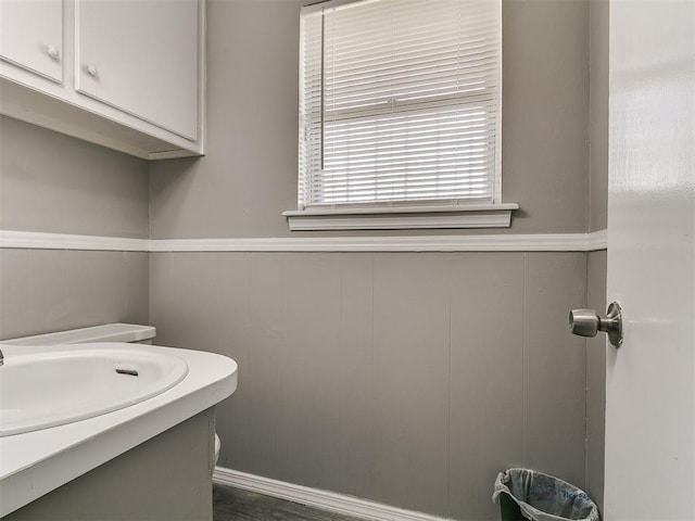 5416 S Independence Ave, Oklahoma City, OK 73119 - bathroom featuring a wainscoted wall and a decorative wall