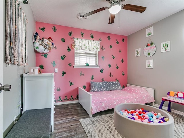 5416 S Independence Ave, Oklahoma City, OK 73119 - bedroom featuring ceiling fan, visible vents, wood finished floors, baseboards, and wallpapered walls