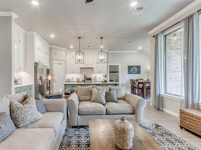 living room featuring light wood-style flooring, recessed lighting, and baseboards
