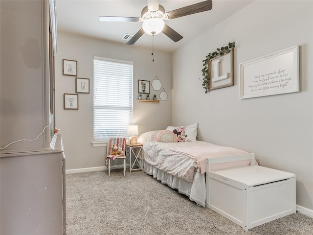 bedroom featuring light carpet, baseboards, and a ceiling fan