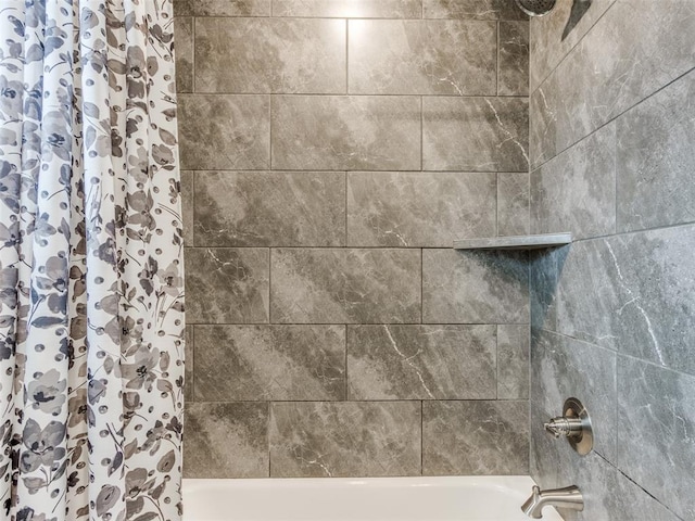 bathroom view of shower / bathtub combination with curtain