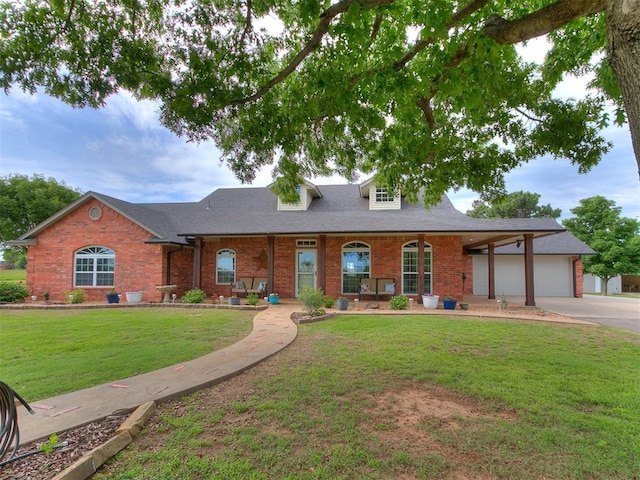 view of front of property featuring a garage, a front yard, brick siding, and driveway