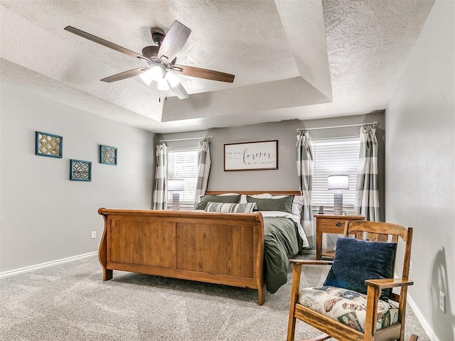 bedroom featuring a textured ceiling, light carpet, baseboards, and ceiling fan
