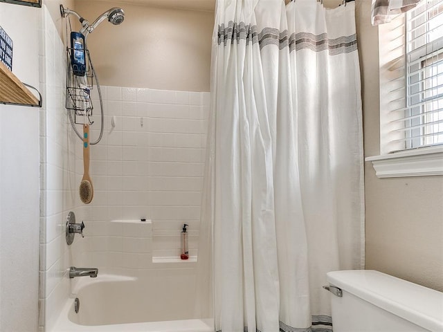 bathroom featuring toilet and shower / bathtub combination with curtain