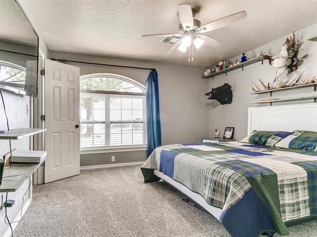 bedroom featuring carpet, a ceiling fan, a textured ceiling, visible vents, and baseboards