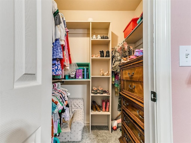 walk in closet with carpet flooring