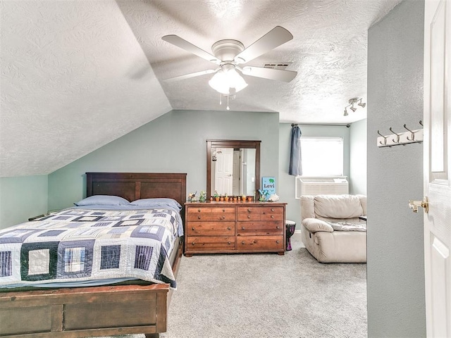 bedroom featuring lofted ceiling, a textured ceiling, cooling unit, visible vents, and carpet floors