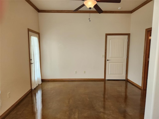 spare room featuring finished concrete floors, crown molding, a ceiling fan, and baseboards