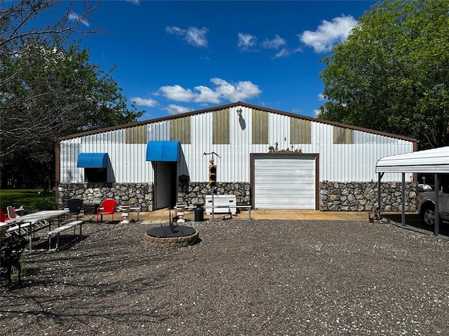 16296 N County Road 3264th Rd, Pauls Valley, OK 73075 - view of home's exterior featuring a garage, dirt driveway, and stone siding