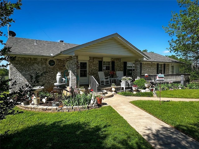 16296 N County Road 3264th Rd, Pauls Valley, OK 73075 - view of front of home with covered porch, a shingled roof, brick siding, and a front yard